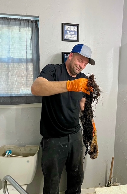 Irvine Plumbing technician removing a drain clog